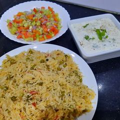A picture of Mater pulao with kaddu raita and kachumar salad.
