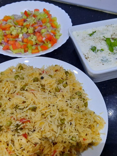A picture of Mater pulao with kaddu raita and kachumar salad.