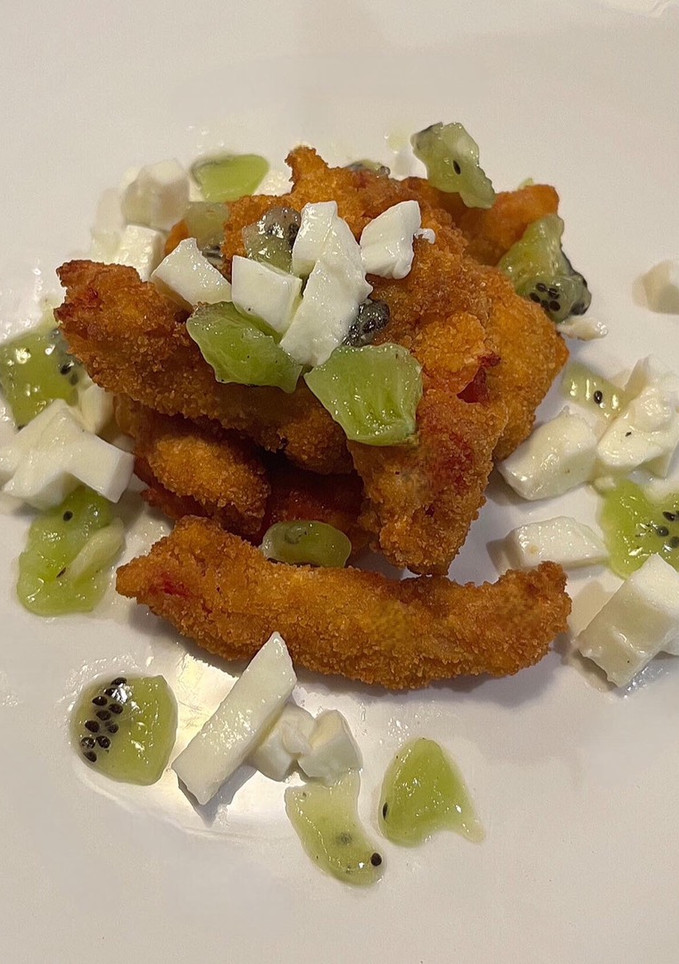 A picture of Tomato goujon with a mozzarella and kiwi salad.
