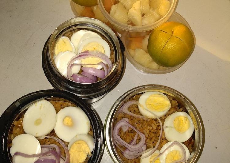 Jollof rice,boiled eggs and fruits