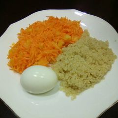 A picture of Carrot salad, boiled egg and boiled rice.