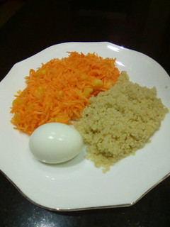 A picture of Carrot salad, boiled egg and boiled rice.