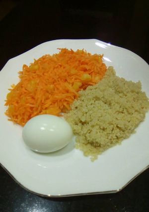 A picture of Carrot salad, boiled egg and boiled rice.