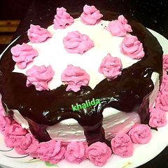 A picture of Three colour layered chocolate drip cake.