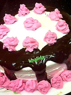 A picture of Three colour layered chocolate drip cake.
