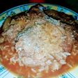 Costilla de cerdo al horno, papas y arroz con salsa