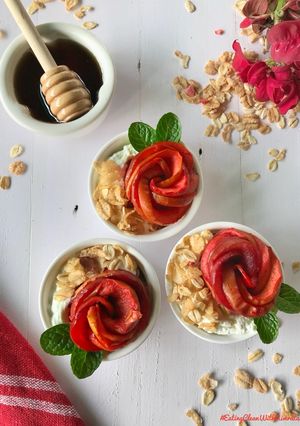 A picture of Poached apple roses in rhododendron juice with muesli and greek yoghurt.