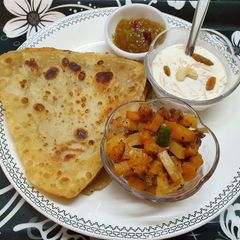Paratha,Pumpkin Curry, Sweet Mango Pickle and Vermicelli Kheer A picture of Paratha,Pumpkin Curry, Sweet Mango Pickle and Vermicelli Kheer.
