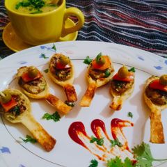 A picture of #Chiken_grill_bite_in_Puff #spoon.With#Lentil_Soup.