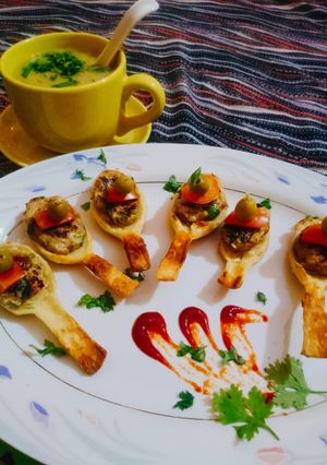 A picture of #Chiken_grill_bite_in_Puff #spoon.With#Lentil_Soup.