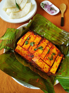 A picture of Paneer wrapped in banana leaf.