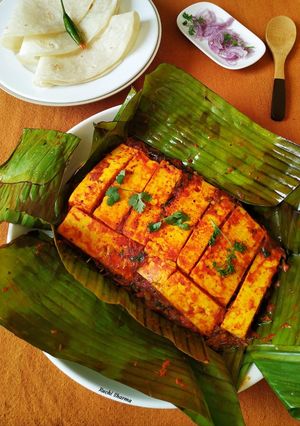 A picture of Paneer wrapped in banana leaf.