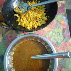 A picture of Tomato Rasam with potato fry.