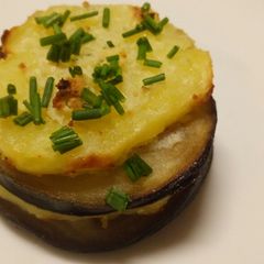 A picture of Aubergine and potato stack with garlic and herb cheese.