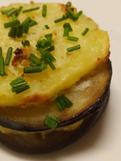 A picture of Aubergine and potato stack with garlic and herb cheese.