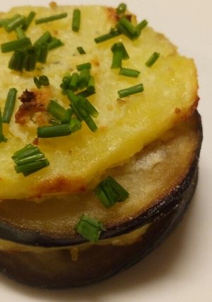 A picture of Aubergine and potato stack with garlic and herb cheese.