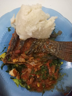 A picture of Simple tilapia in a bed of green veggies.