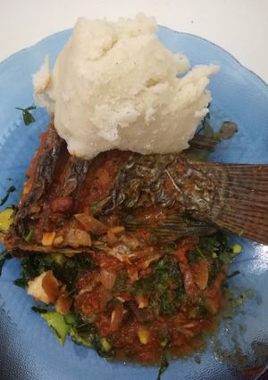 A picture of Simple tilapia in a bed of green veggies.