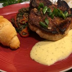 A picture of Paprika Pork Chops w/ Peach Mint Purée & Creamy Coconut Curry Lentils.