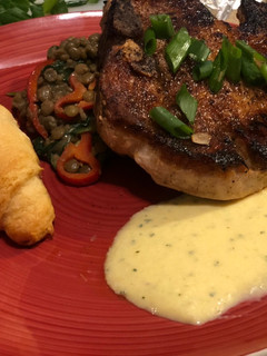 A picture of Paprika Pork Chops w/ Peach Mint Purée & Creamy Coconut Curry Lentils.