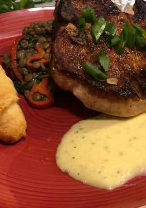 A picture of Paprika Pork Chops w/ Peach Mint Purée & Creamy Coconut Curry Lentils.