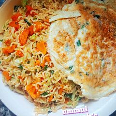 A picture of Vegetable Noodle jollof n fry eggs.