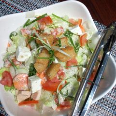 A picture of Ice berg salad with italian dressing.