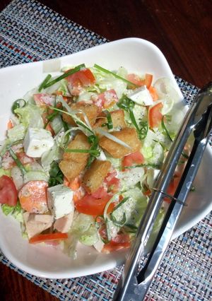 A picture of Ice berg salad with italian dressing.