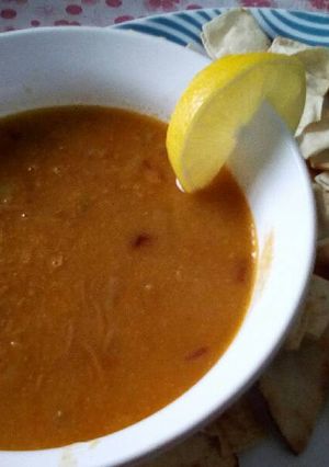 A picture of Lentil Soup with Toasted Pita Bread.