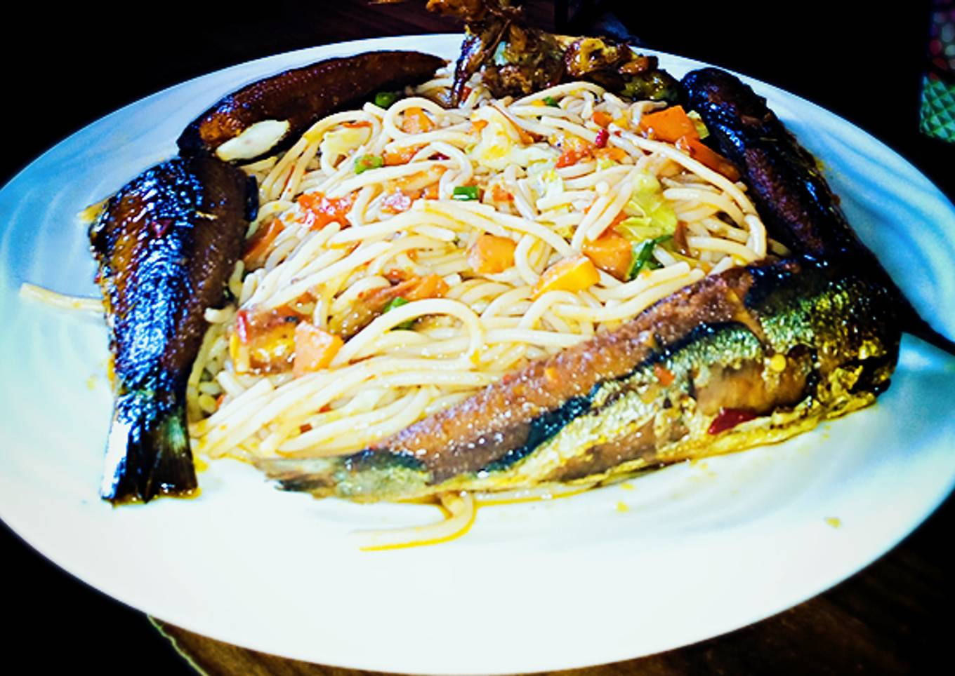 Veggie jollof spaghetti with fried fish