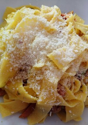 A picture of Papardelle with speck and chanterelle mushrooms.