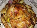 Roast chicken with potatoes,onion and garlic