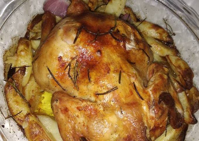 Roast chicken with potatoes,onion and garlic