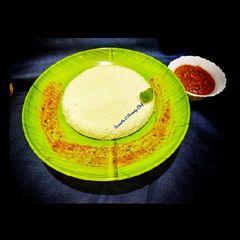 A picture of Plate idli with tomato fenugreek chutney.