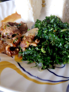 A picture of Beef stew, greens served with ugali.