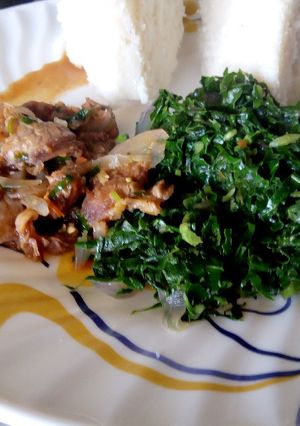 A picture of Beef stew, greens served with ugali.
