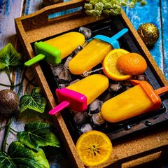 A picture of Orange lollies|Orange Popsicles.