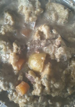 A picture of Rich beef stew with dumplings.