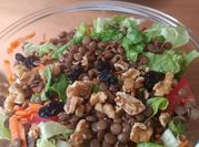Una foto de ensalada de rúcula arándano