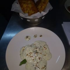 A picture of Revioli with garlic bread.