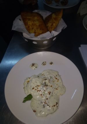 A picture of Revioli with garlic bread.