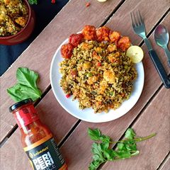 A picture of Peri Peri prawn fritters in spicy spinach rice.