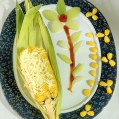 A picture of CHEESY BUTTERI CORN on COB.