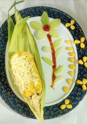 A picture of CHEESY BUTTERI CORN on COB.