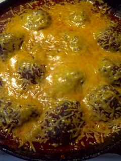 A picture of Meatballs in marinara sauce.