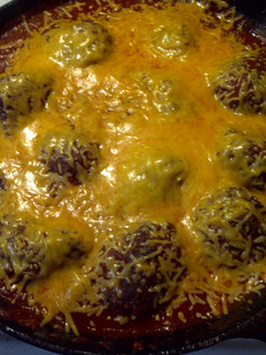 A picture of Meatballs in marinara sauce.