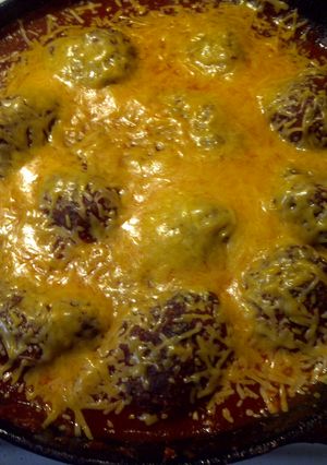 A picture of Meatballs in marinara sauce.