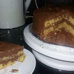 A picture of Orange fruit cake with chocolate frosting.