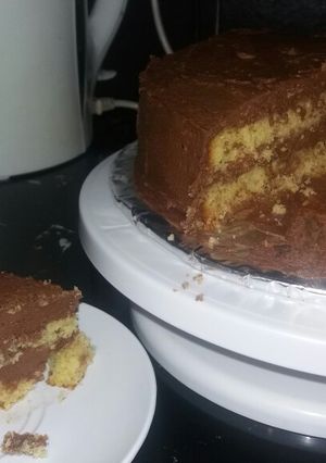 A picture of Orange fruit cake with chocolate frosting.