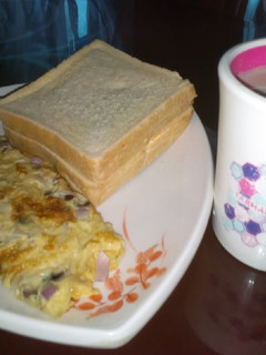 A picture of Fried egg with bread and tea.